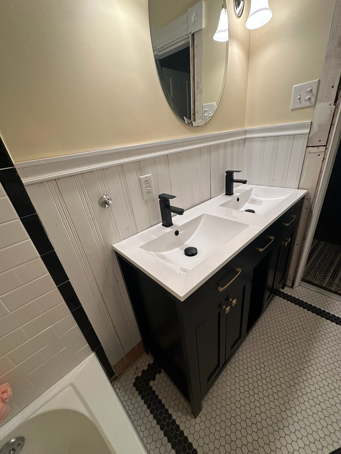 Double vanity installed during the upstairs bathroom update before the new mirrors and lighting