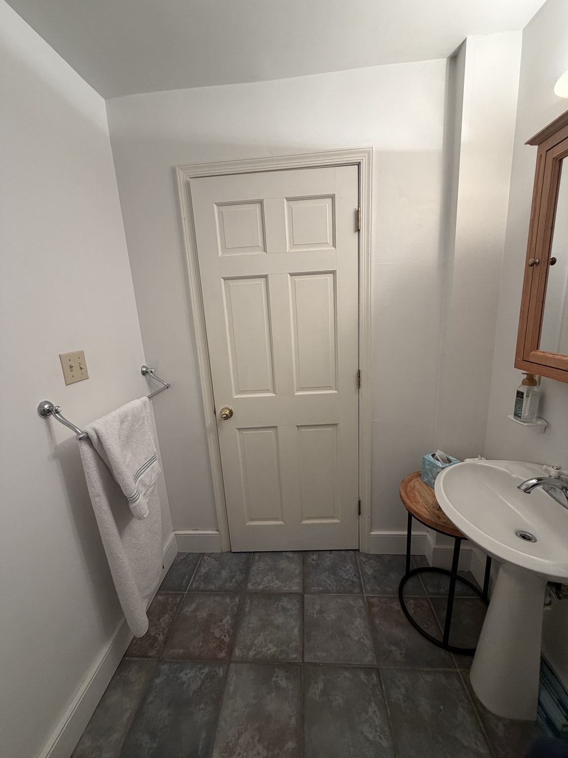 Original hinged bathroom door swinging into the small room