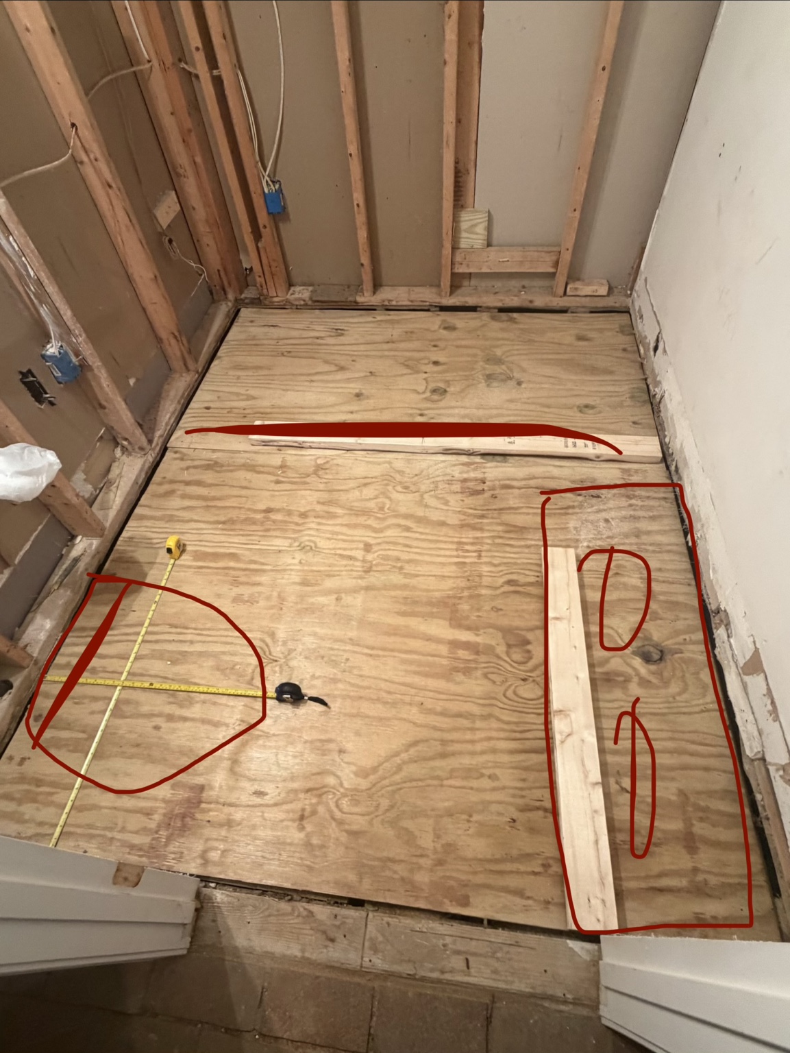 Alternate bathroom layout marked in red on the plywood subfloor