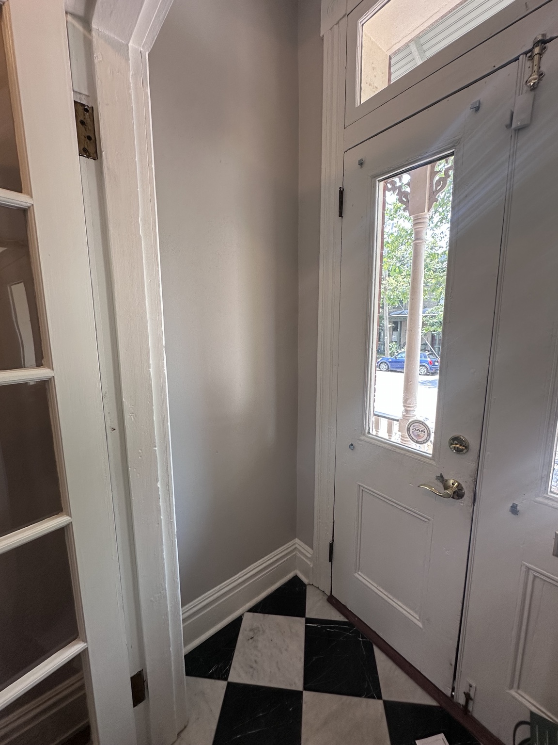 The empty vestibule wall before beadboard, hooks, and storage were added
