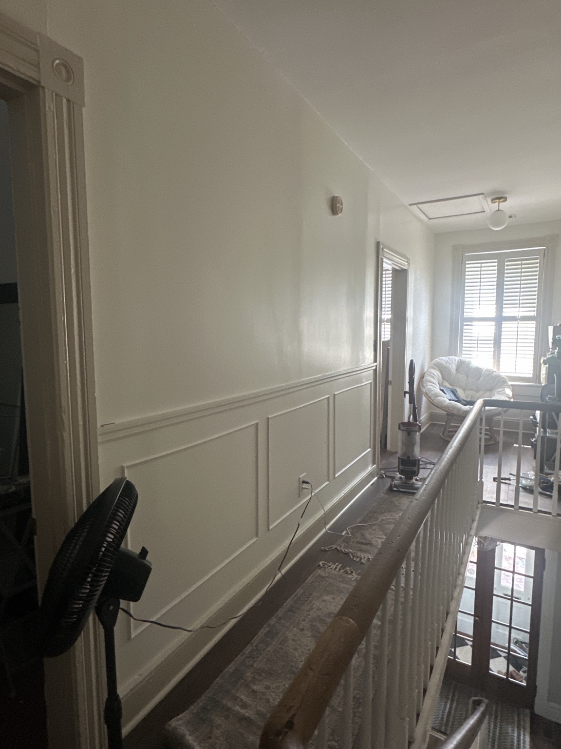 Picture frame molding installed along the upstairs hallway wall