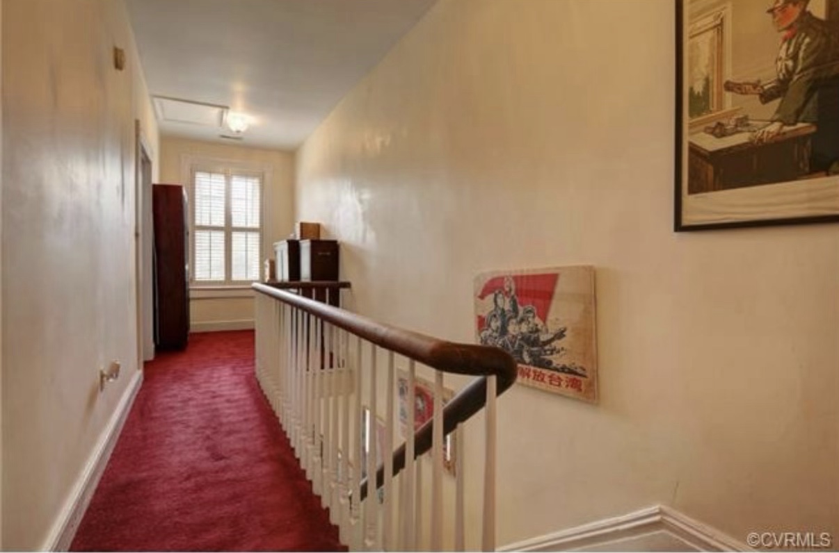 Upstairs hallway before renovation with bright red wall-to-wall carpet