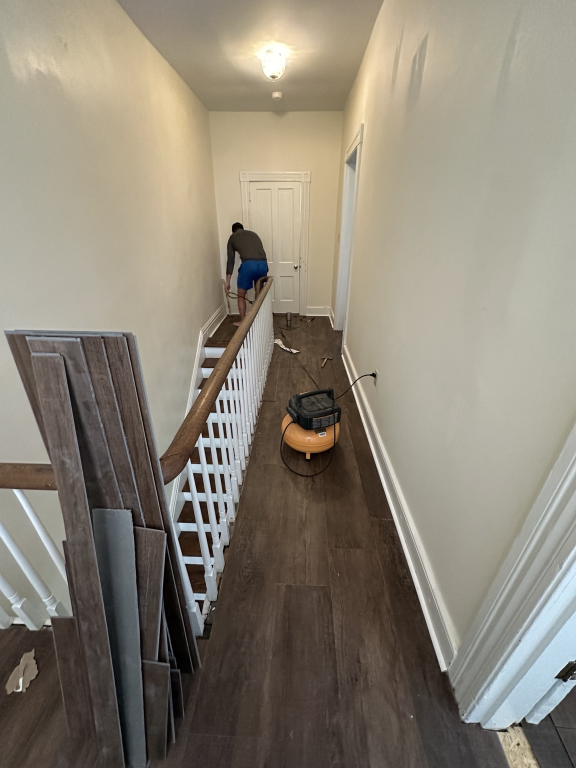 Work underway in the upstairs hallway beside the open stairwell